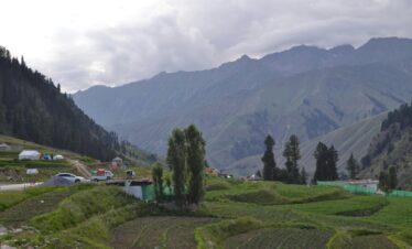 Majestic view of Batakundi's lush fields and mountains in Pakistan.